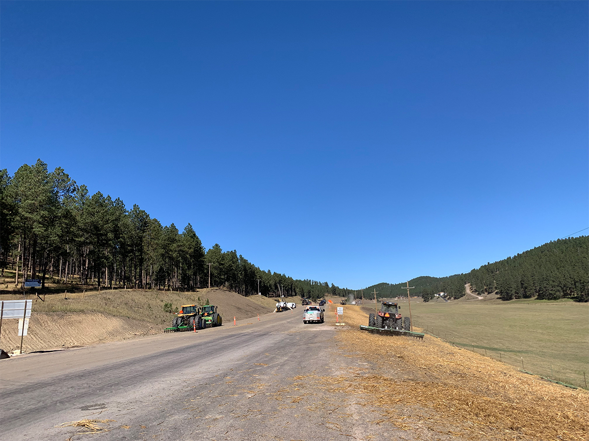 Various construction vehicles parked on flat road base